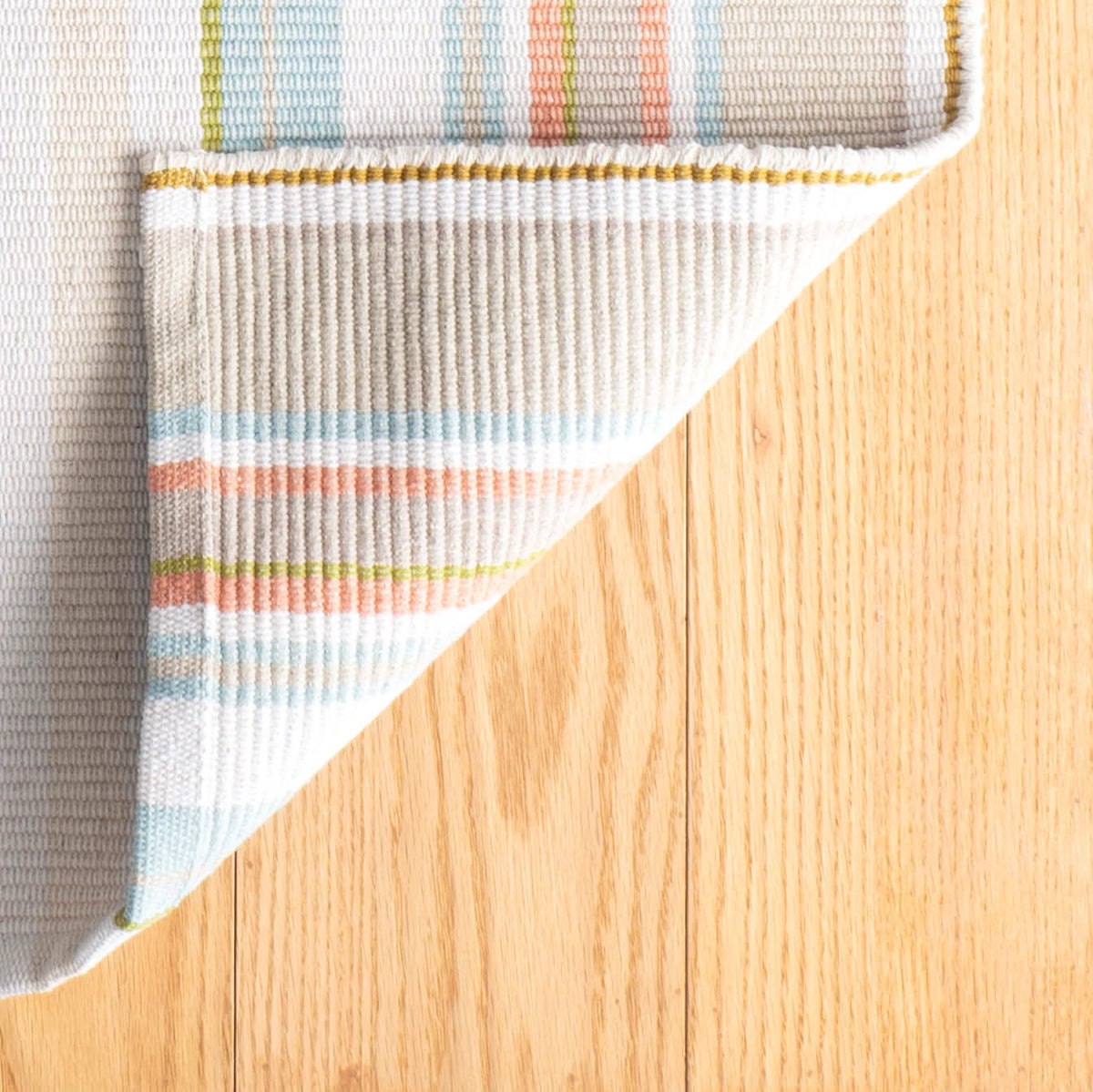 Daphne Stripe Handwoven Cotton Rug, Sky, styled in a room - Starboard Lane