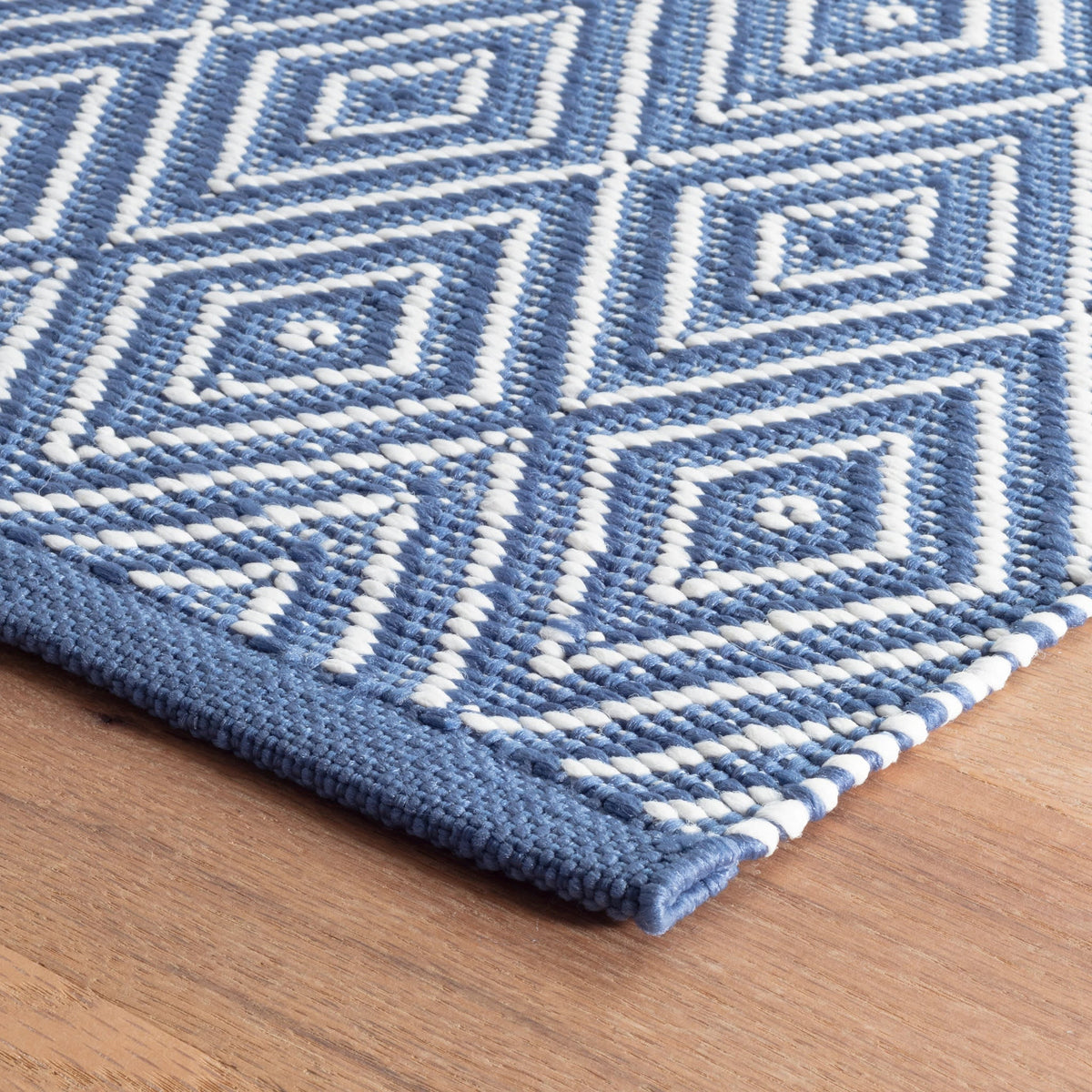 Diamond Indoor/Outdoor Rug, Denim/White, styled in a room - Starboard Lane