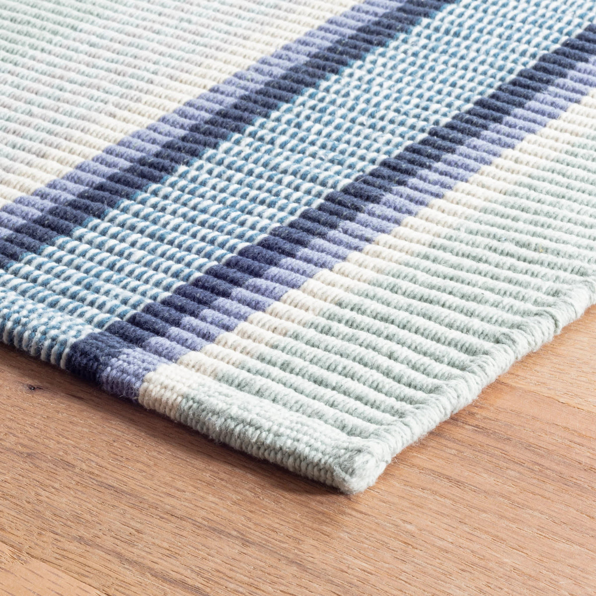 Barbados Stripe Handwoven Cotton Rug - Blue, styled in a room - Starboard Lane