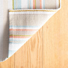 Daphne Stripe Handwoven Cotton Rug, Sky, styled in a room - Starboard Lane