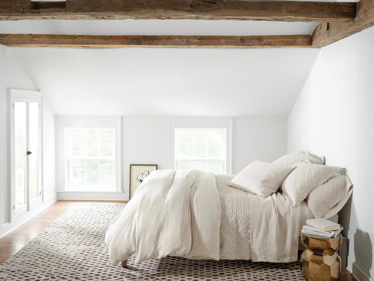 Washed Linen Quilt, Natural, styled on the bed - Starboard Lane