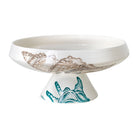 Lido Pedestal Bowl, white Italian earthenware hand painted with a taupe seashell on the bowl and teal shell on the base