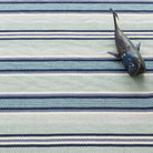 Barbados Stripe Handwoven Cotton Rug - Blue, styled in a room - Starboard Lane