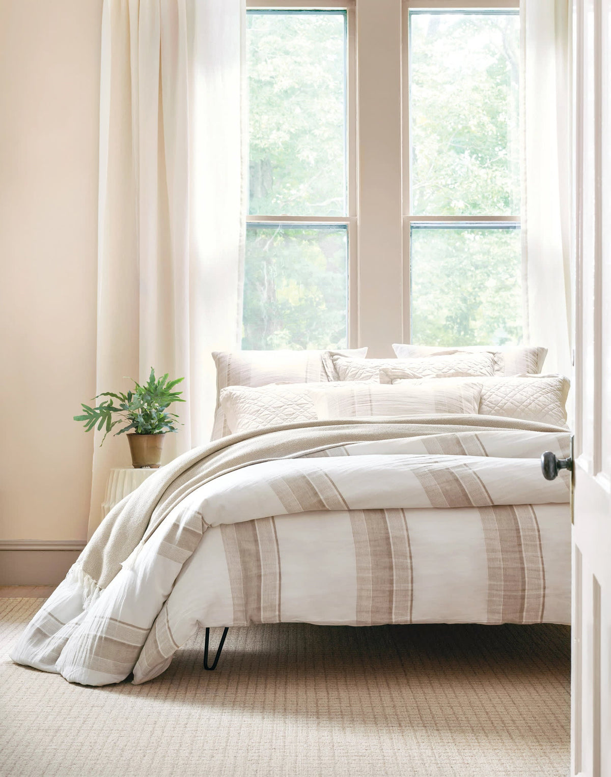 Washed Linen Quilt, Natural, styled on the bed - Starboard Lane