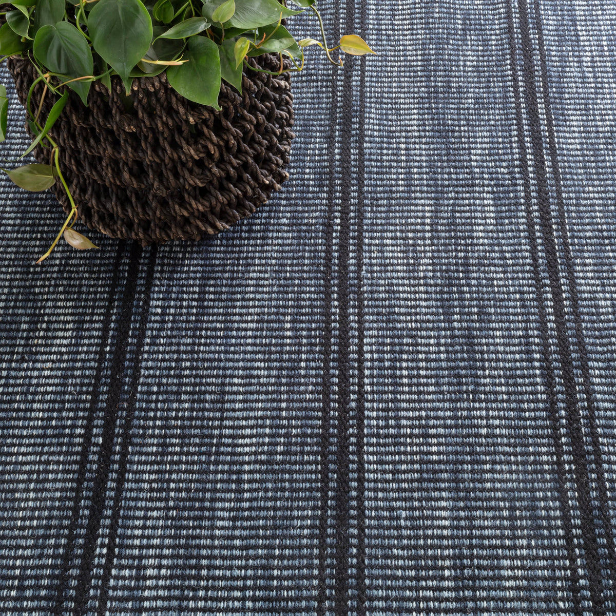 Malta Handwoven Wool Rug, Navy, styled in a room - Starboard Lane