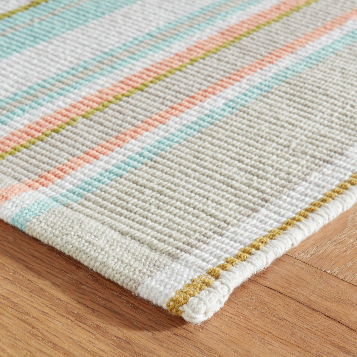 Daphne Stripe Handwoven Cotton Rug, Sky, styled in a room - Starboard Lane