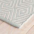 Diamond Indoor/Outdoor Rug, Light Blue/Ivory, styled in a room - Starboard Lane