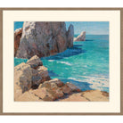 Painting of sunlit rocky cliffs above turquoise sea, floated on a cream mat in a light walnut frame