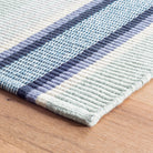 Barbados Stripe Handwoven Cotton Rug - Blue, styled in a room - Starboard Lane