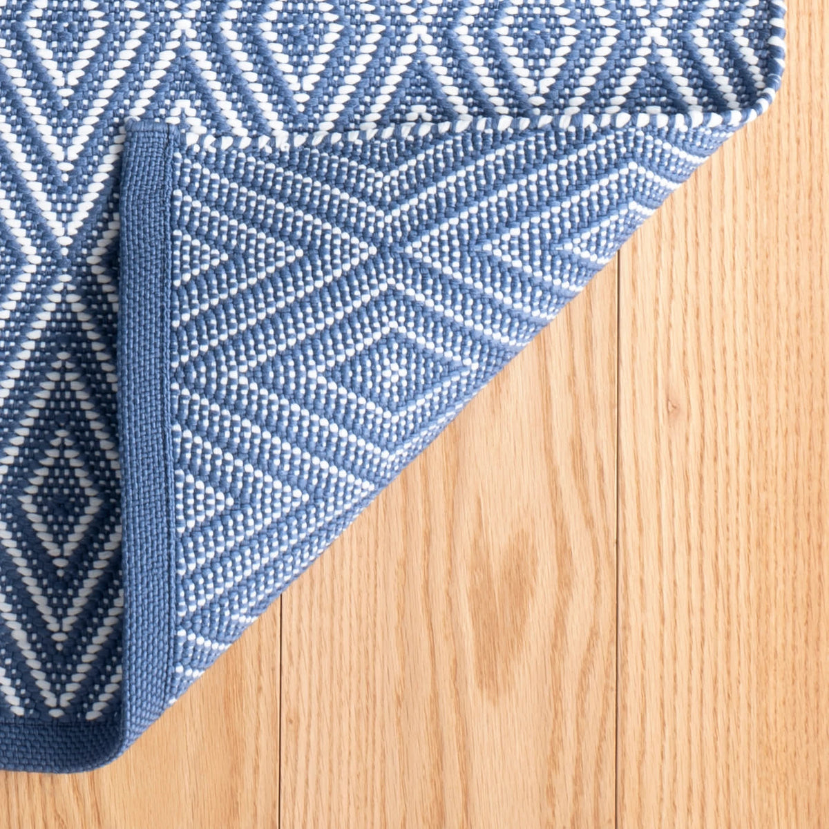 Diamond Indoor/Outdoor Rug, Denim/White, styled in a room - Starboard Lane