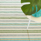 Long Slade Handwoven Cotton Rug, Teal, styled in a room - Starboard Lane