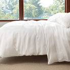Silken Solid Sheet Set, White, styled on the bed - Starboard Lane