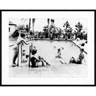 Vintage black and white photograph of swimmers lounging around a resort pool