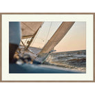 Photograph from the deck of a racing sailboat with billowing sail at golden hour