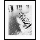 Vintage black and white photograph of a line of water skiers in formation