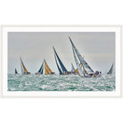 Photograph of racing yachts with white and gold sails on glittering water