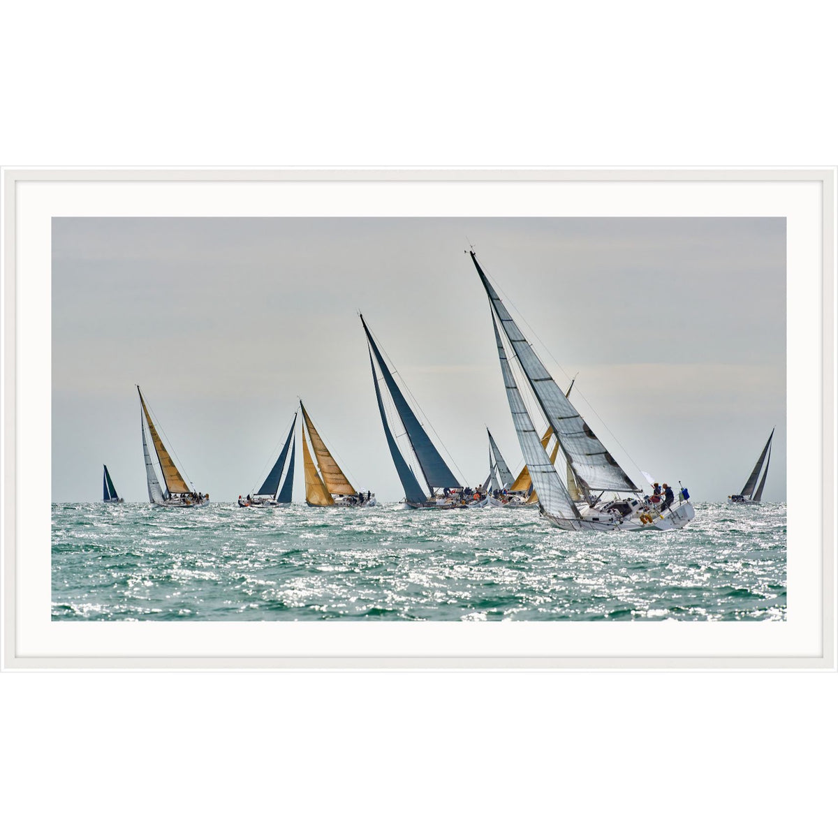 Photograph of racing yachts with white and gold sails on glittering water